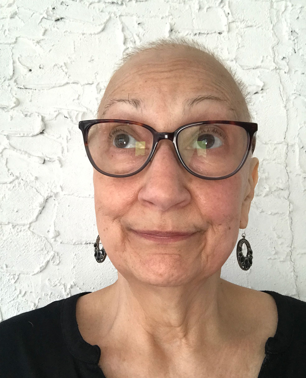Claire, an older white woman with closely cropped hair and large glasses