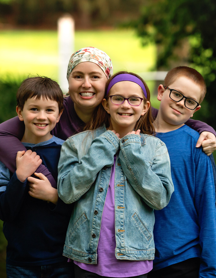 Jenni Hetzel-Gaynor smiling with her three children