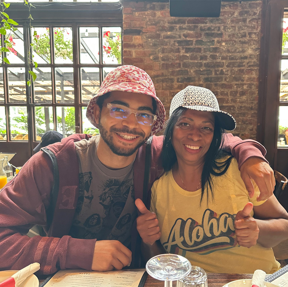 Kimberley Robinson smiling with her son at a restaurant