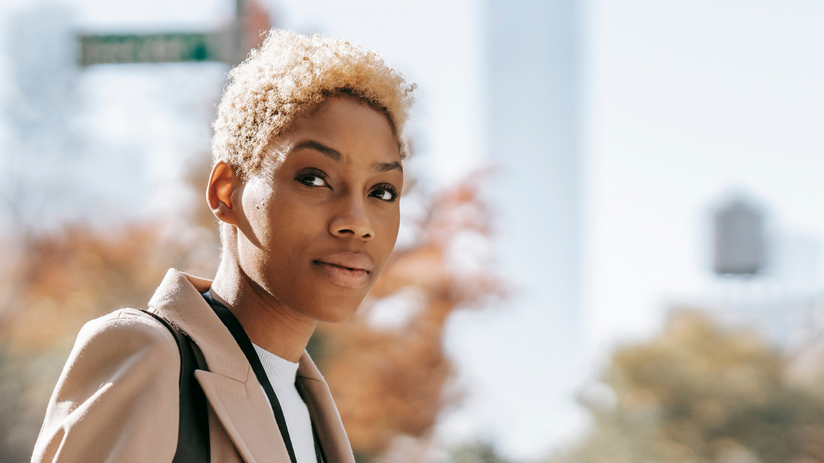 A Black woman with short, blond hair