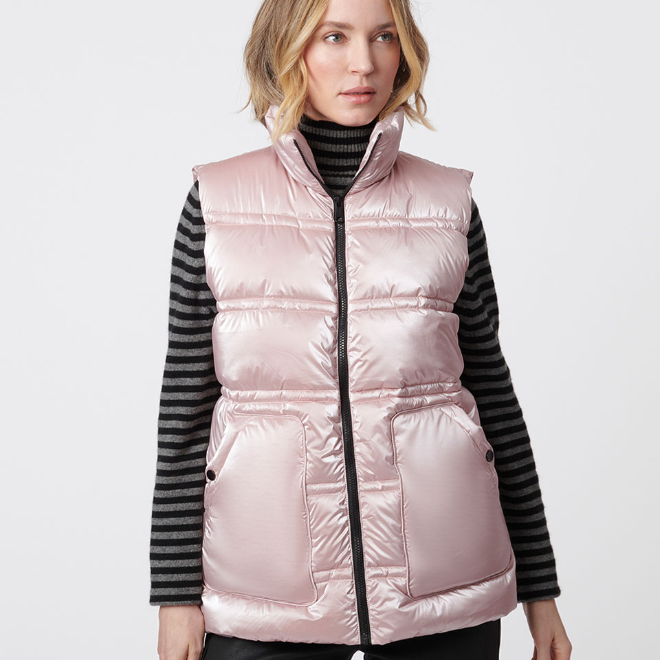 A woman modeling a pink Bernardo puffer vest.