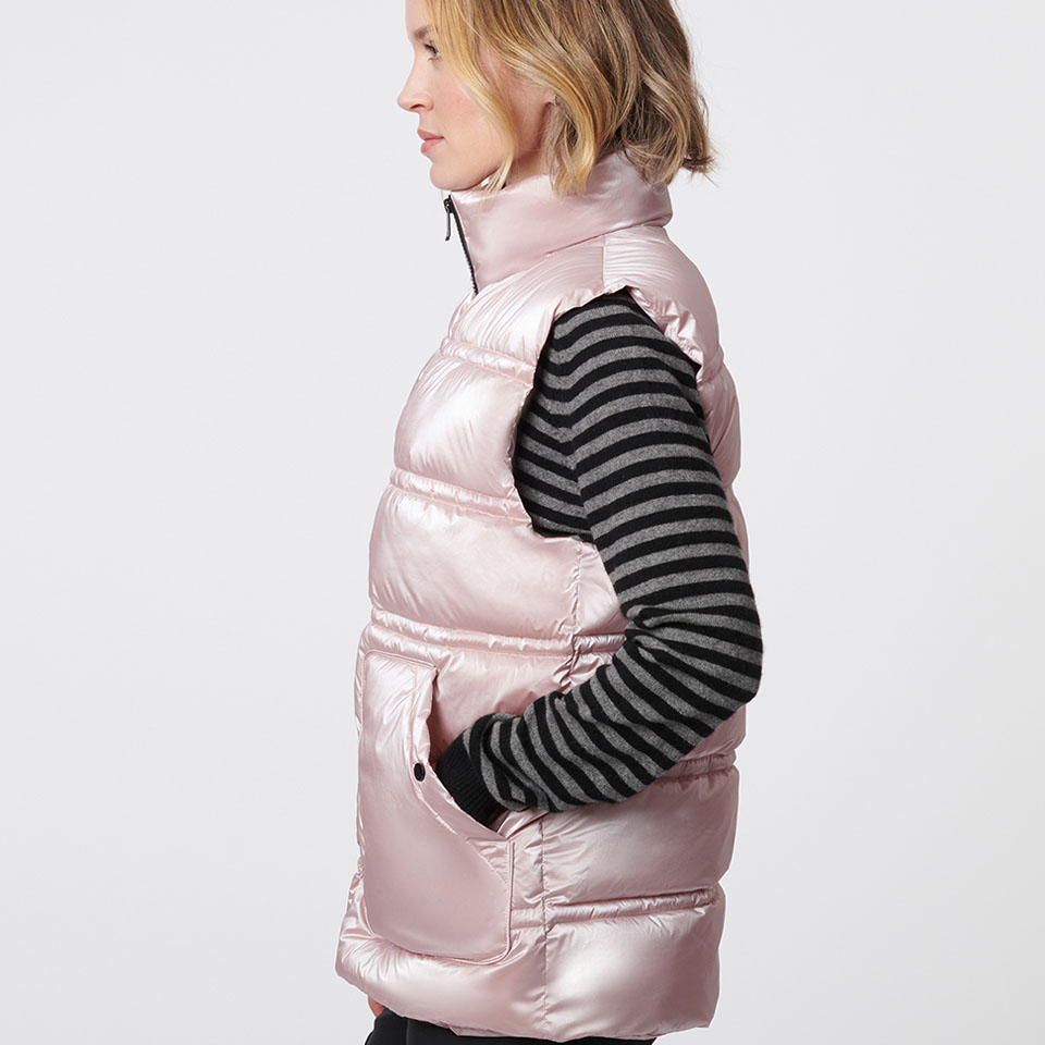 A woman modeling a pink Bernardo puffer vest.