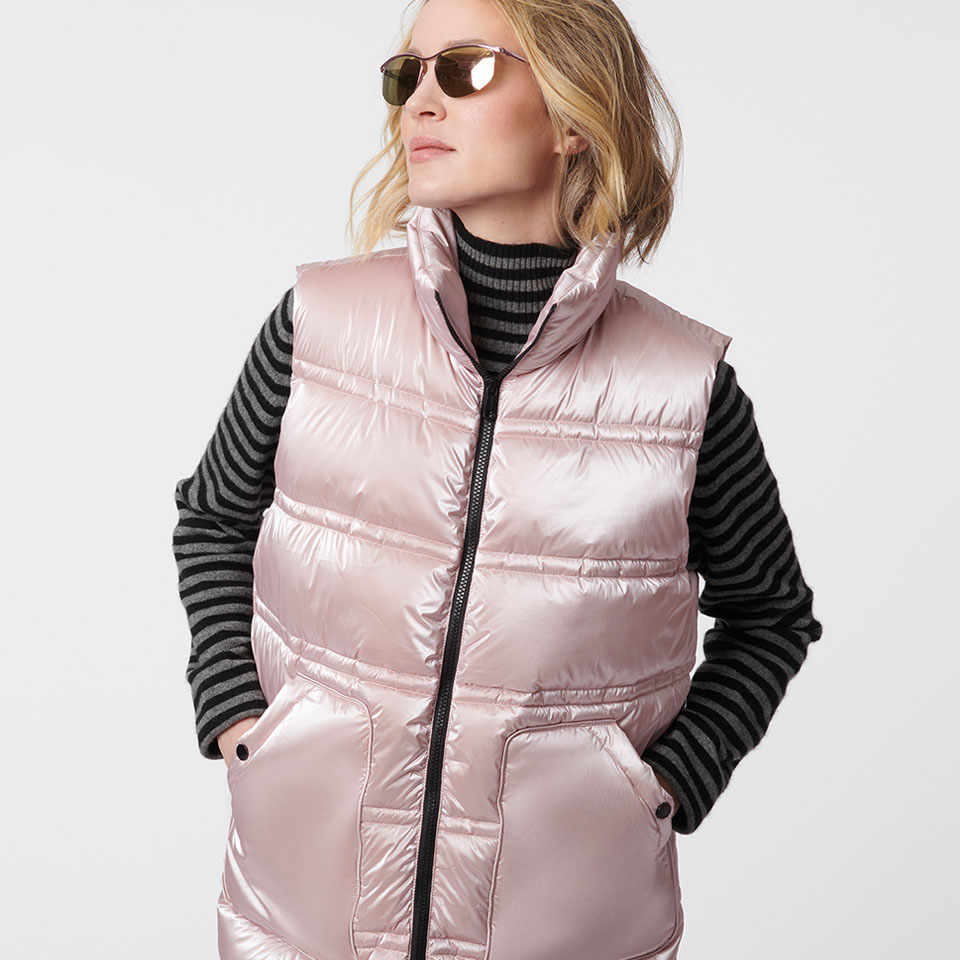 A woman modeling a pink Bernardo puffer vest.