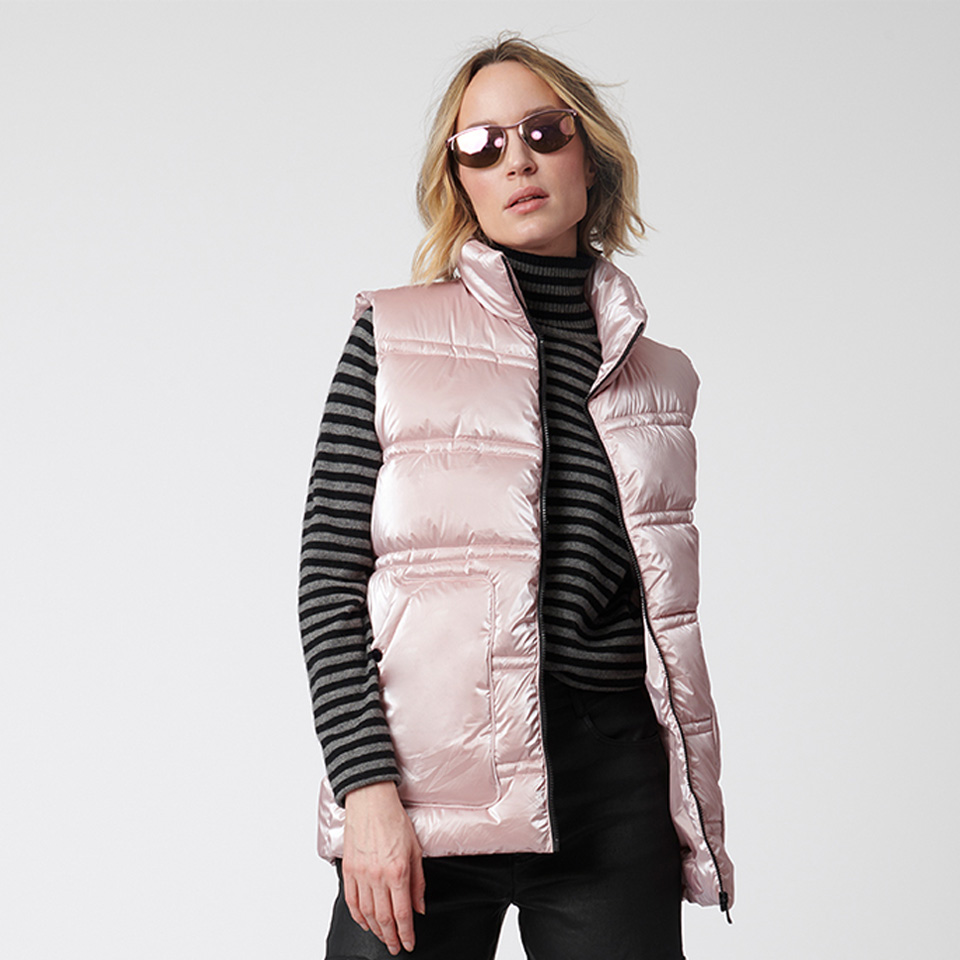 A woman modeling a pink Bernardo puffer vest.