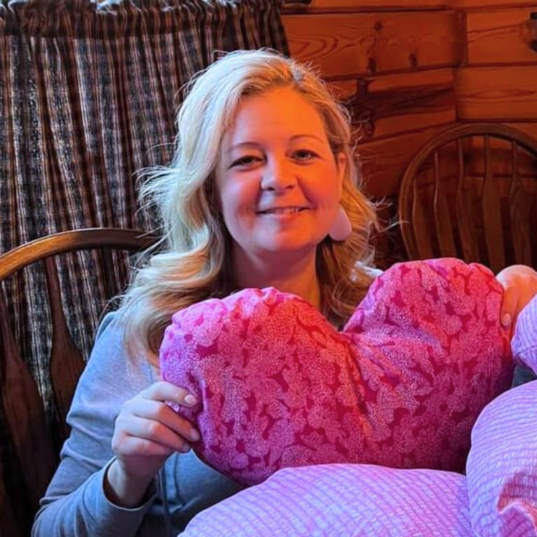 Jamie Gallagher proudly displays a pink heart pillow