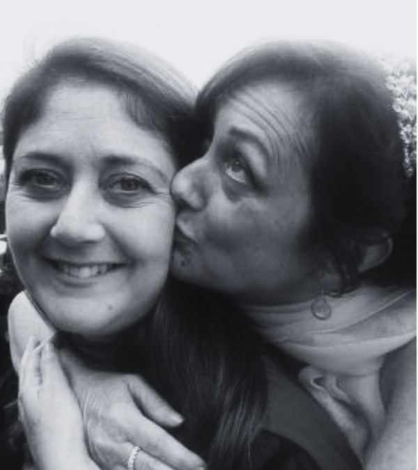 Lynn Folkman kisses her sister Deb on her wedding day.