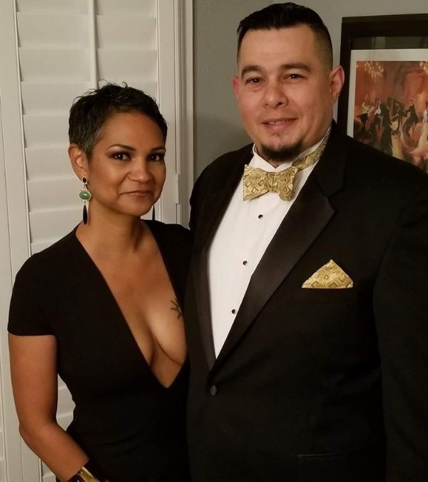 Miranda Gonzalez and her husband pose proudly in formal wear.