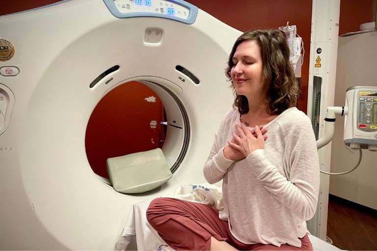 Bethany Adair breathes mindfully in a yoga pose before her CT scan.